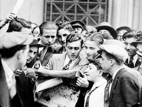 In this 1929 file photo, stock brokers and others crowd arounds newspapers after the Wall Street stock market crash. Eddie Jackson photo/KRT.