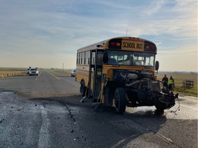 A school bus involved in a collision with a semi-truck is pictured at the intersection of Highway 810 and Highway 505 in Cardston County.