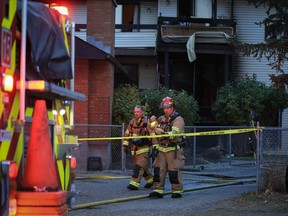 Calgary firefighters work at the scene of a fatal fire in Bowness on Thursday, October 20, 2022.