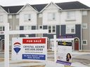 Homes for sale in a new subdivision in Airdrie, Alta., Friday, Jan. 28, 2022. The Calgary Real Estate Board says home sales in the Alberta city for September were down nearly 12 percent compared to the same month last year.  The board says home sales totaled 1,901 for the month, as sales of detached homes fell 23 percent from a year ago and sales of semi-detached homes retreated 27 percent.