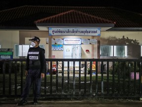A police officer stands guard outside a child care centre on Oct. 06, 2022, in Uthai Sawan subdistrict, Nong Bua Lamphu, Thailand. Thai police said a former police officer Panya Kamrab had killed at least 38 people, including 24 children in a mass shooting and stabbing at the care centre.