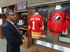 Dr Derek McKay, director of the Snyder Institute, with hockey memorabilia arranged at the University of Calgary.