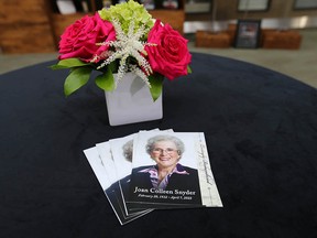 Service cards bearing a photo of Joan Snyder are arranged on a table at a ceremony at the University of Calgary on Friday, Oct. 28, 2022. The Snyder estate has donated $67.5 million to medical research at the university.