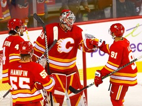 Goaltender Jacob Markstrom is congratulated by teammates after the Calgary Flames defeated the Colorado Avalanche 5-3 in the Flames’ season-opener at the Scotiabank Saddledome in Calgary on Thursday, Oct. 13, 2022.