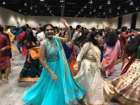 Crowds dance to traditional music at the first part of Navaratri celebrations at the BMO Centre on October 1, 2022.