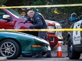 Police investigate after an officer was shot in the 500 block of Canyon Meadows Drive S.W. just before 3 a.m.