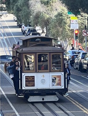 San Francisco's steep streets are best explored hanging from its famous cable cars.  Photo by James Ross