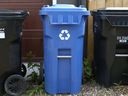 A City of Calgary black and blue bins are shown at the back of a home in Calgary's SE Ramsey neighborhood on Friday, May 27, 2016. 