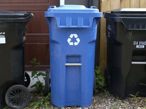A City of Calgary's black and blue bins are shown in the rear of a home in the SE neighborhood of Ramsey in Calgary on Friday, May 27, 2016.