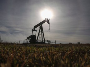 A pumpjack works at a well head on an oil and gas installation near Cremona, Alta.