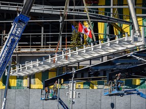 The steel beam signed by participants, contributors and members involved in the BMO expansion project is lifted into place to mark the completion of the BMO Center Expansion's steel structure on Thursday, November 3, 2022.