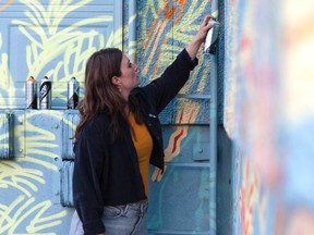 Artist Nicole Wolf works on Journeys Home, a mural at the Calgary Dream Centre. Courtesy, Nicole Wolf.