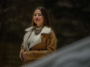 Anastasiia Haiduchenko, who fled Russian-occupied Kherson, poses for a portrait outside her home in Calgary on Monday, Nov. 7, 2022.