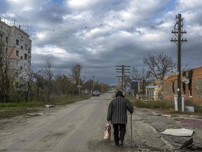 File photo: An old woman walks through a village in the Kherson region of Arhanherske, previously occupied by Russian forces, November 3, 2022.