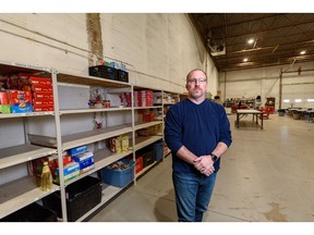 Charles Redeker, manager of the Veterans Association Food Bank in Calgary, stands beside empty shelves on Wednesday, November 9, 2022.