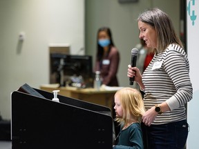 Katie Fraser, with her daughter Scarlett, speaks at a media event announcing a $10 million donation from the Taylor Family Foundation that will fund a new neonatal unit at Foothills Hospital.