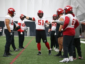 Members of the Calgary Stampeders offensive line practise in Calgary on Wednesday, Nov. 2, 2022. The team practised indoors at the new inflatable dome at the Shouldice Athletic Park.