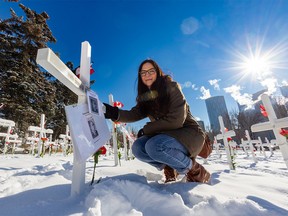 Calgarian Stephanie Watts is photographed in the Field of Crosses next to her great-great-grandfather Samuel Daniel Watts' cross on Wednesday November 9, 2022.