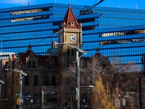 Calgary’s old city hall is framed against the newer building on Monday, November 21, 2022.