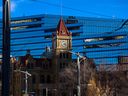 Calgary's old city hall is framed against the newer building on Monday, November 21, 2022. 