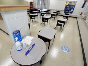 Masks and sanitizer for COVID-19 precautions as well as physically spaced desks are seen inside St. Marguerite School in New Brighton on Tuesday, August 25, 2020.