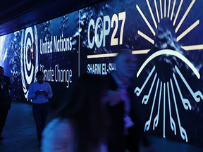 Conference participants walk through an illuminated tunnel at the COP27 climate conference in Sharm el-Sheikh, Egypt. The conference runs from Nov. 6 to 18.