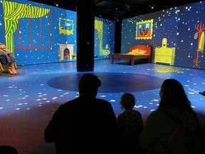 An image of a family in the digital immersion experience of Good Night Moon at Telus Spark in Calgary, Alberta.