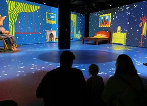 An image of a family in the digital immersion experience of Good Night Moon at Telus Spark in Calgary, Alberta.