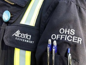 An Alberta Occupational Health and Safety officer stands at a press conference on Monday May 12, 2014 in Edmonton Alta.
