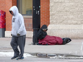 A homeless person is seen trying to stay warm in downtown Calgary on January 25, 2021.