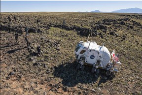 Members of the NASAs Desert Research and Technology Studies team practice on a prototype lunar rover for future Artemis missions at Black Point Lava Flow near Flagstaff, Arizona, on October 24, 2022. Olivier Touron / AFP