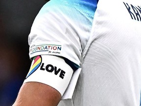 In this file photo taken on September 24, 2022, England's forward Harry Kane wearing a rainbow armband. reacts after losing the UEFA Nations League's League A Group 3 match between Italy and England, at the San Siro Stadium in Milan. -