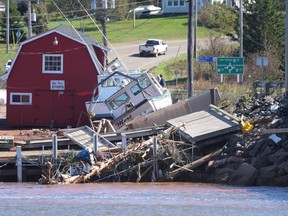Damage from post-tropical storm Fiona at the wharf in Stanley Bridge, P.E.I. on Sunday September 25, 2022. The federal government's new national adaptation strategy seeks to help Canadians withstand the floods, fires and heat waves climate change is expected to unleash.