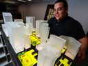 Alberto de Salvatierra, assistant professor of urbanization and data in architecture at the University of Calgary, is photographed Monday, Nov. 21, 2022, with a model illustrating parking in a downtown environment.  Gavin Young/Postmedia.