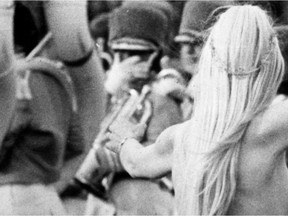 A woman streaks across the field during the opening ceremonies of the 1975 Grey Cup at McMahon Stadium. Calgary Herald archives.