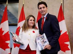 Deputy Prime Minister and Minister of Finance Chrystia Freeland and Prime Minister Justin Trudeau stop for a photo before delivering the fall economic statement on Parliament Hill in Ottawa, Nov. 3, 2022.