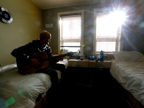 Resident Christian plays the guitar in his room at the Fresh Start Recovery Center in Calgary on Wednesday, November 16, 2022. Darren Makowichuk/Postmedia