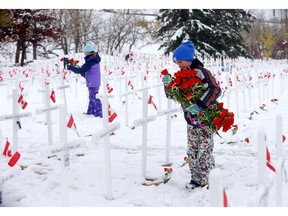 Student Malaea Dennis, 9, from Delta West Academy along with teachers, students and their families continued their 10-plus years tradition of placing poppies at the Field of Crosses along Memorial Drive in Calgary on Sunday, October 23, 2022.