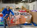 Volunteer Herta Glimpel puts a hammer together at the Calgary Food Bank on October 26.  Rising inflation means more Calgarians are turning to the Food Bank.