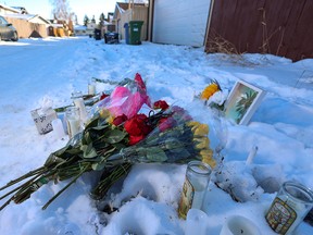 A memorial is shown in a Falconridge alley where Nathan Ward was fatally shot on Saturday.