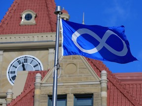 The Métis National Flag flies outside Calgary City Hall for the official opening of Métis Week on Monday.