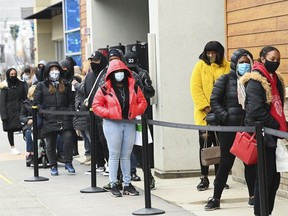 People line up at the Toronto Premium Outlets mall on Black Friday for shopping sales, in Milton, Ont., Friday, Nov. 27, 2020. Experts say they expect big blowout sales and blockbuster one-day deals this Black Friday will draw consumers to stores in numbers not seen since pre-pandemic days.THE CANADIAN PRESS/Nathan Denette