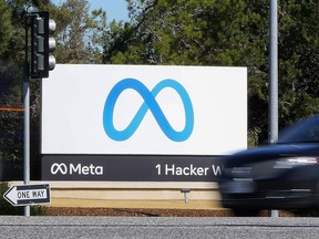 FILE - A car passes Facebook's new Meta logo on a sign at the company headquarters on Oct. 28, 2021, in Menlo Park, Calif. Facebook parent Meta on Wednesday, Oct. 26, 2022, reported that its revenue declined for a second consecutive quarter, hurt by falling advertising revenue amid competition from the wildly popular video app TikTok.