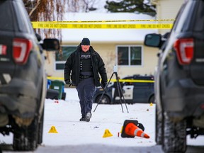 Calgary police investigate in an alley behind Falconridge Place NE after a fatal shooting on Saturday, November 12, 2022.