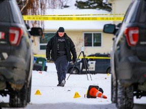 Calgary police investigate in an alley behind Falconridge Place N.E. after a fatal shooting on Saturday, November 12, 2022.