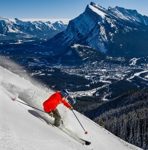 Andre Quenneville carves turns down Boundary Bowl at Banff’s Mount Norquay on Nov. 13, 2022, with Mount Rundle and the town of Banff in the background on opening weekend. Al Charest, Postmedia