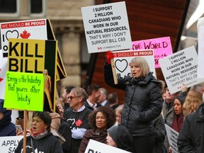 Pro-pipeline supporters rally across the street from the Fairmont Palliser Hotel on March 25, 2019.