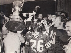 A shower of champagne for 1975 game hero Dave Cutler. Postmedia archives.