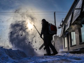 Aaron Stott with Bugaboo Landscaping clears snow along Edmonton Trail on another frigid  day in Calgary on Wednesday, December 21, 2022.