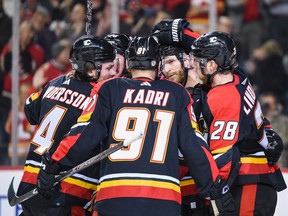 The Calgary Flames celebrate a goal during a 3-2 win over the Arizona Coyotes at the Scotiabank Saddledome in Calgary on Monday, Dec. 5, 2022.